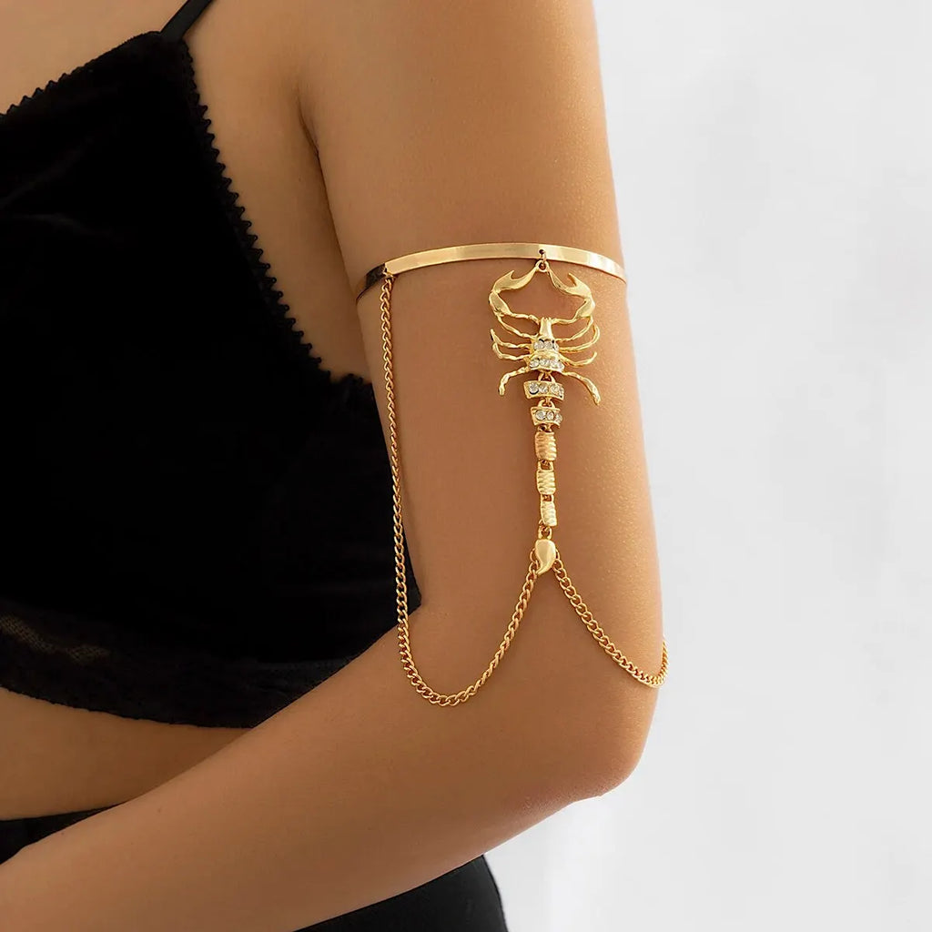 Gold scorpion arm cuff with chain details